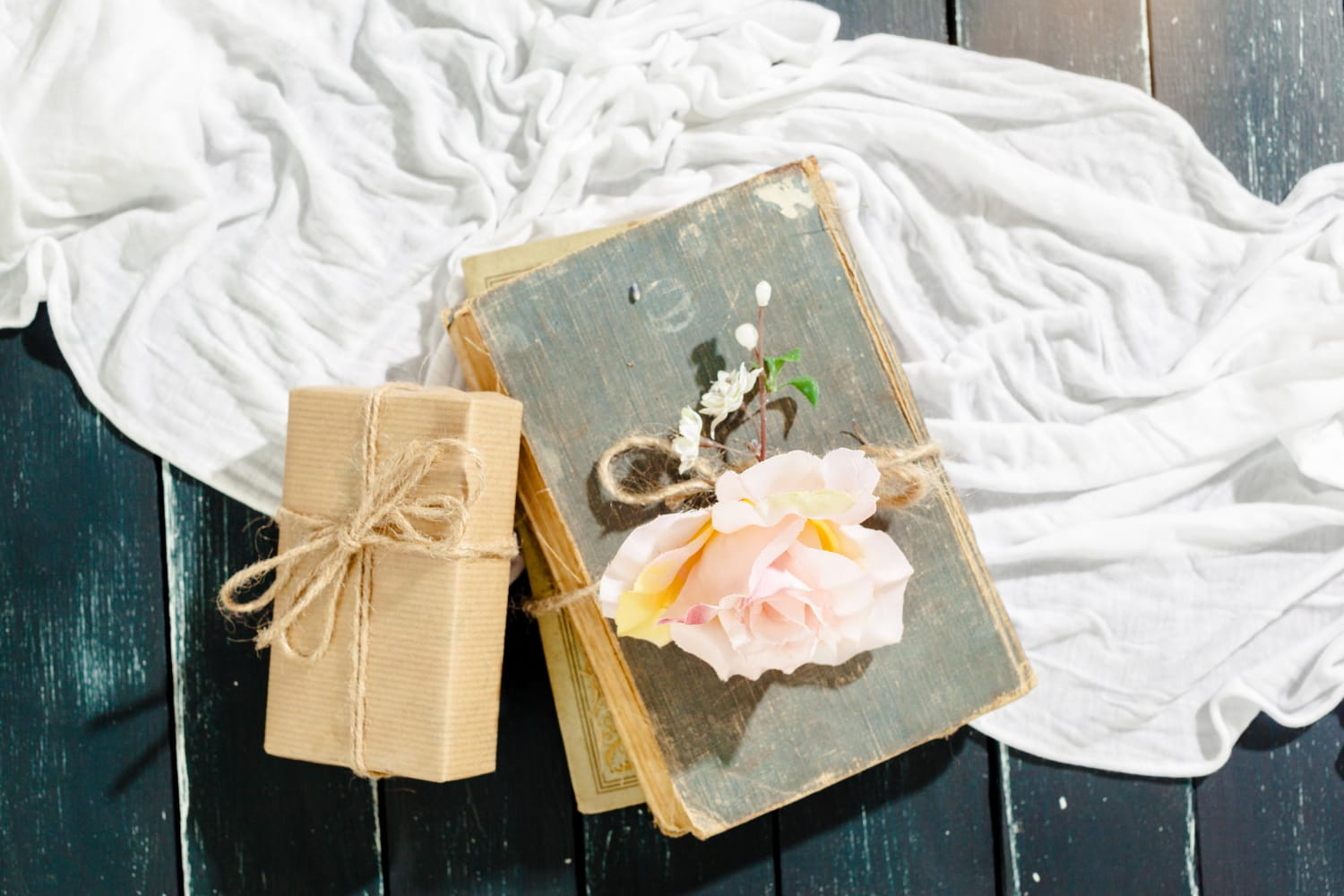 A collection of personalized gifts for women including a wax seal stamp, jewelry organizer and custom mug arranged on a pastel surface